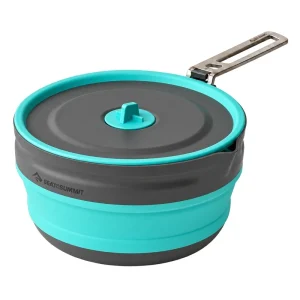 Turquoise collapsible cooking pot with charcoal lid, turquoise lid tab and extended metal handle on white.