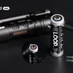 USB-C cable charging the removable LOOP GEAR battery beside the SK03 RGB flashlight