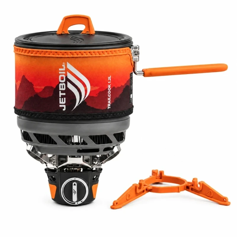 Jetboil TrailCook 1.2L Sunset stove system with lid, extended orange handle and orange canister stabilizer, shown complete on a white background