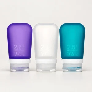 humangear GoToob+ three-pack 2.5 fl oz / 74 mL, purple left, frosted clear white center, dark teal right