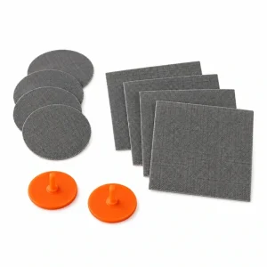 Sea to Summit Air Sprung Cell mat repair kit with round and rectangular patches and orange valve inserts on white